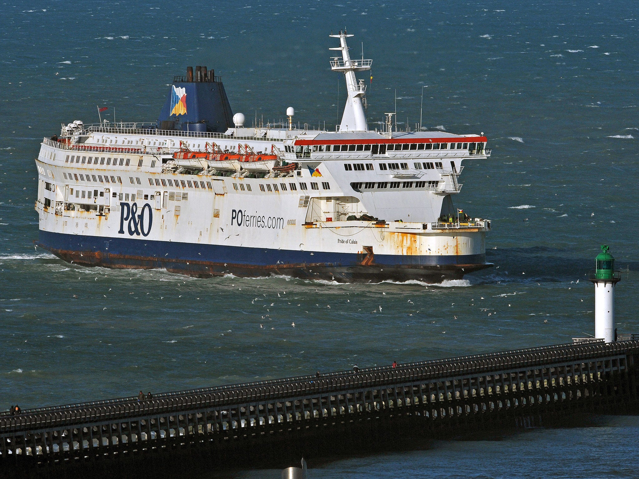 P&O ferry Pride of Calais arrives at the Calais' harbour, northern France, on January 2, 2012, with the white cliffs of Dover in the background. Acquired by Ports, Customs and Free Zone Corporation of Dubai in March 2006, the Peninsular & Oriental Steam N
