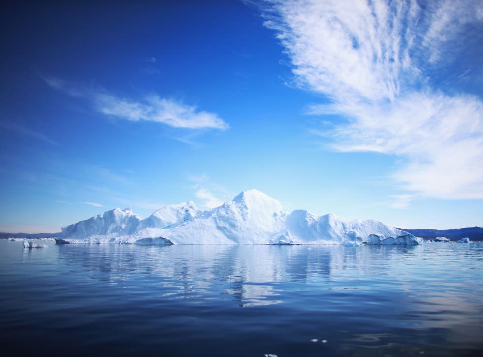 An iceberg floats through the water on July 20, 2013 in Ilulissat, Greenland. As Greenlanders adapt to the changing climate and go on with their lives, researchers from the National Science Foundation and other organizations are studying the phenomena of 