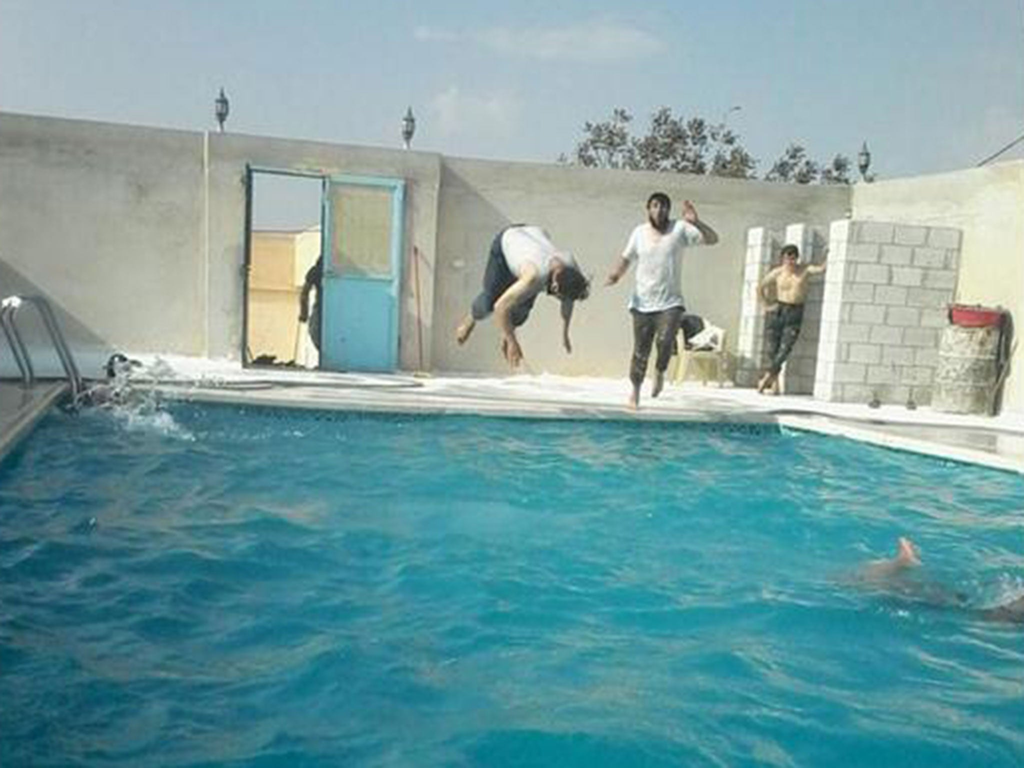 Militants in a swimming pool in Aleppo