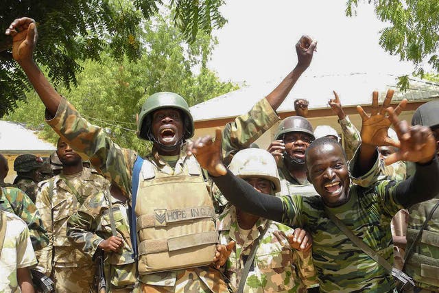 Nigerian soldiers jubilating after recapturing areas of Baga, North East Nigeria 