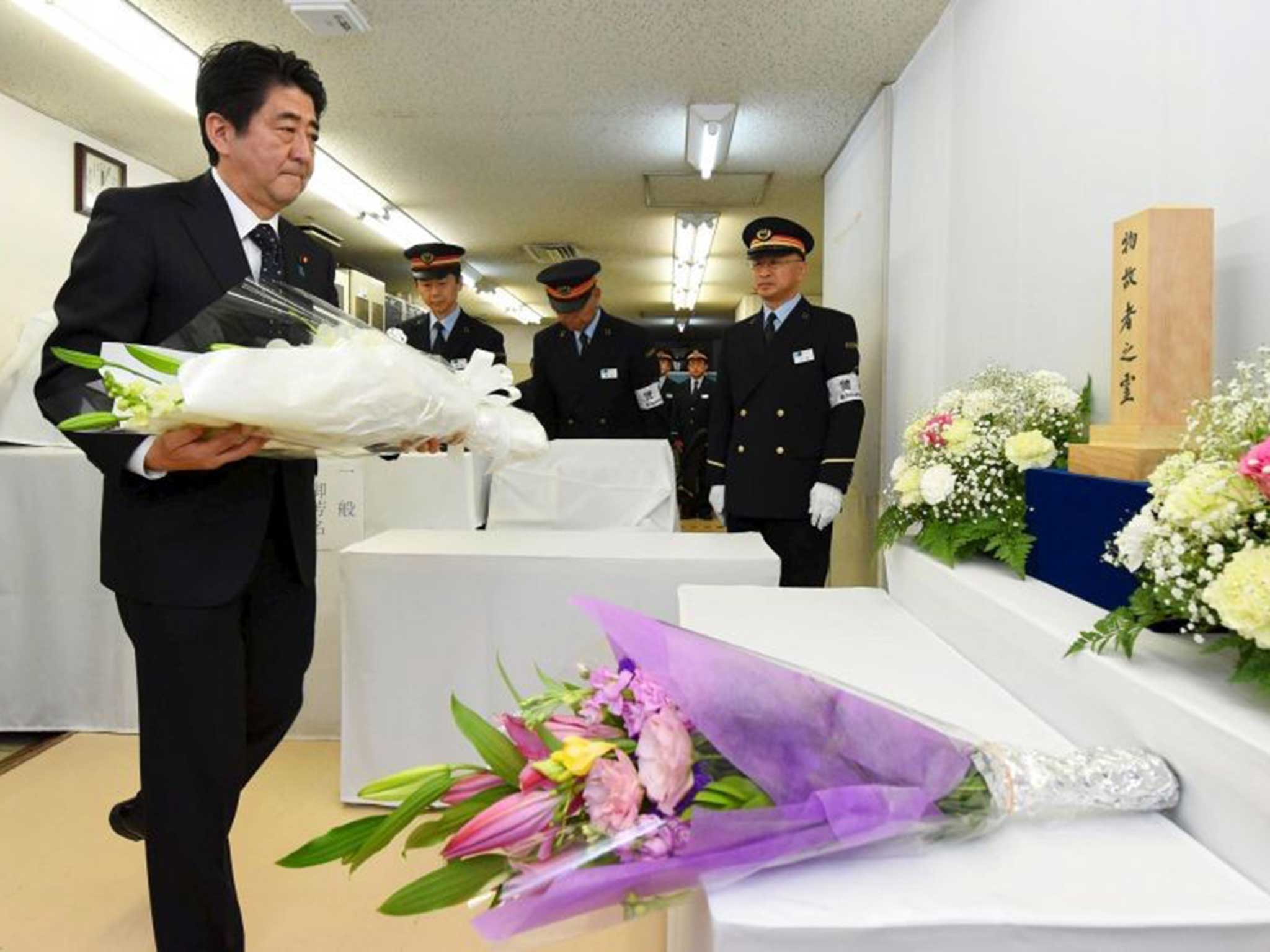Prime Minister Shinzo Abe lays flowers