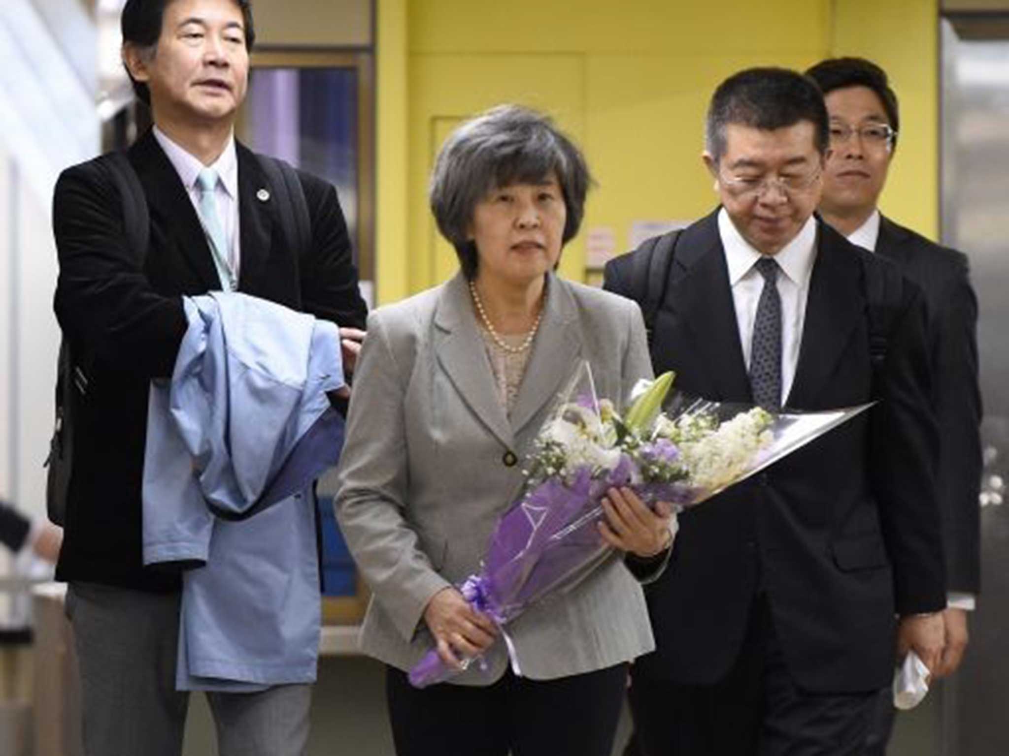 Shizue Takahashi, widow of a subway officer who was killed, arrives to lay flowers