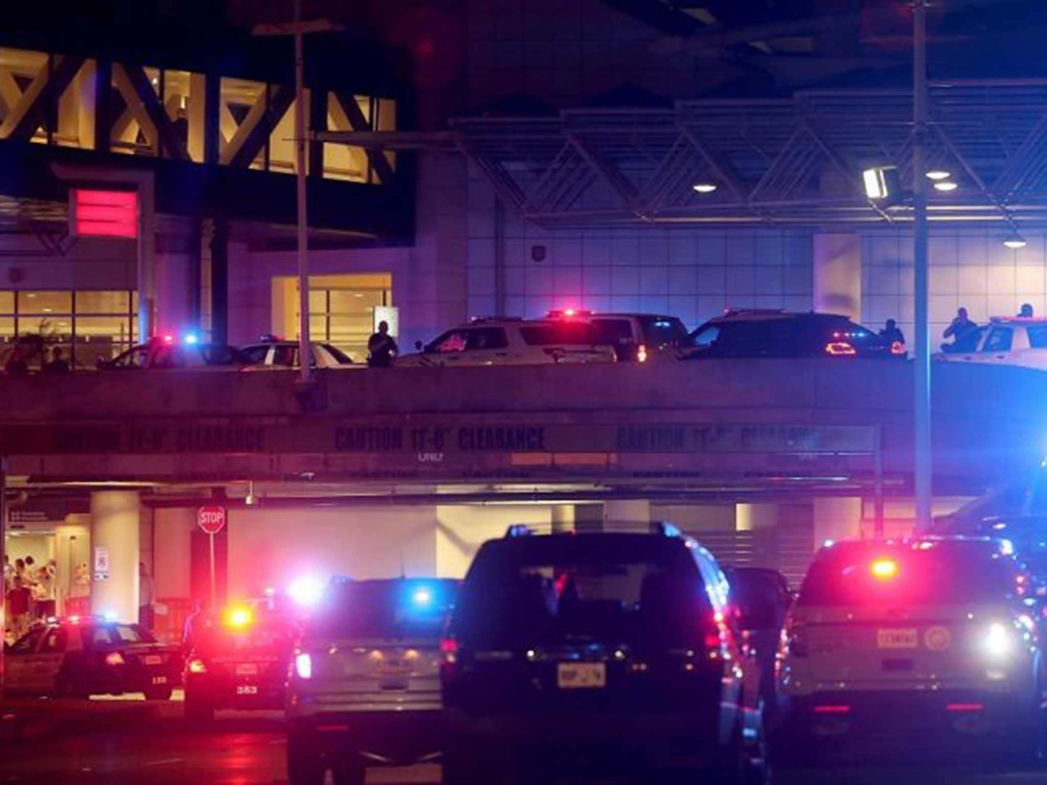 Dozens of police vehicles surround the entrance to New Orleans Louis Armstrong International Airport