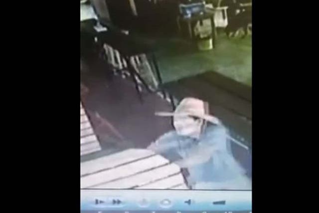 A member of staff appears to try and stop the man from shooting 