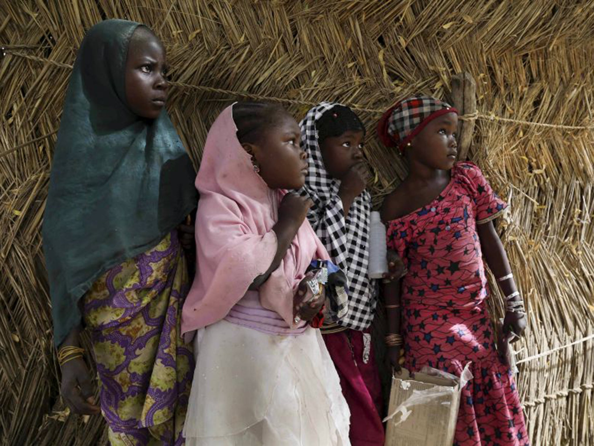 Nigerian girls watch as troops from Niger and Chad enter Damasak