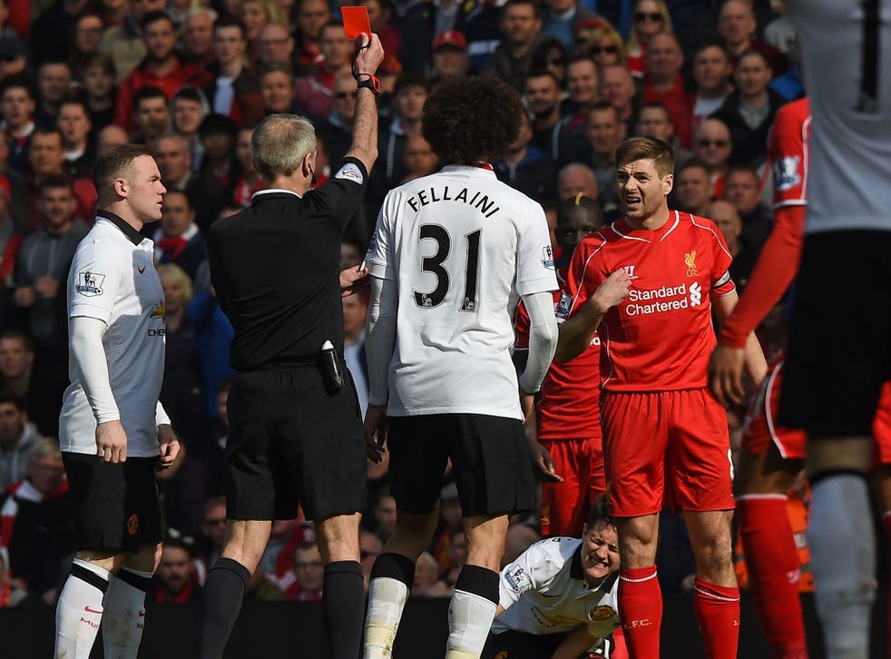 Referee Martin Atkinson shows Steven Gerrard the red card