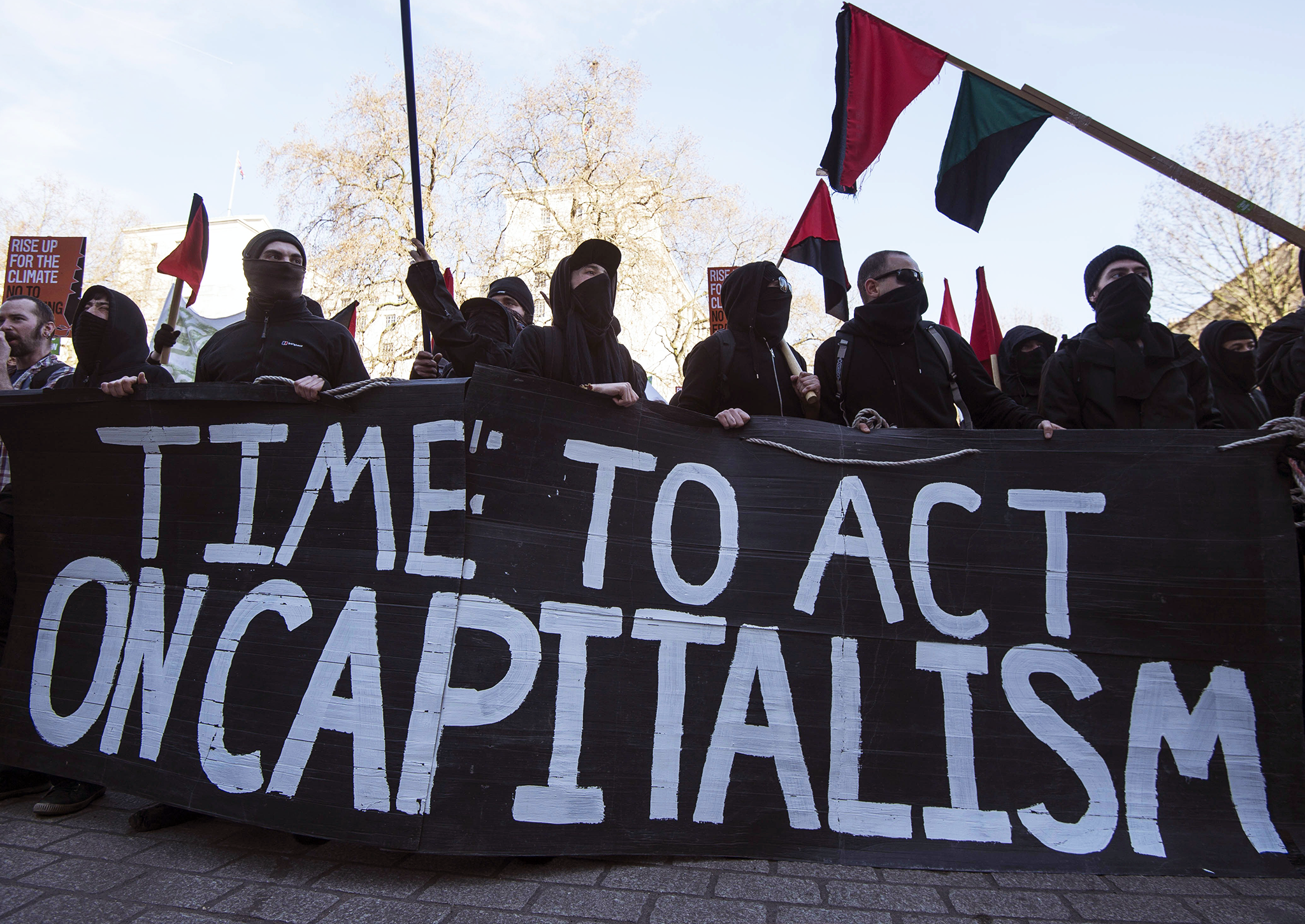 Anti-capitalist demonstrators display a banner outside Downing Street in March, 2015