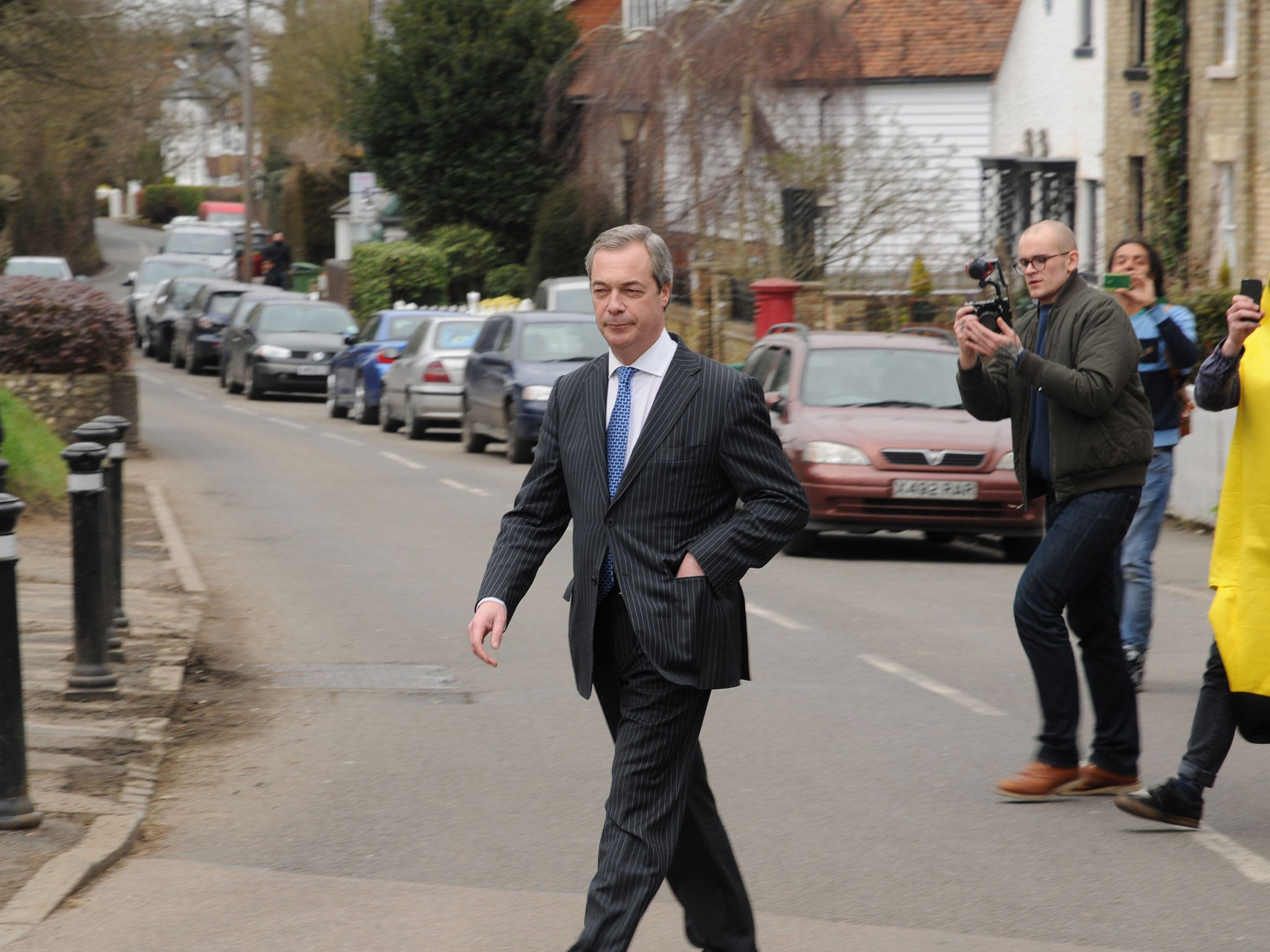 Nigel Farage is pictured leaving the pub after the invasion by protesters