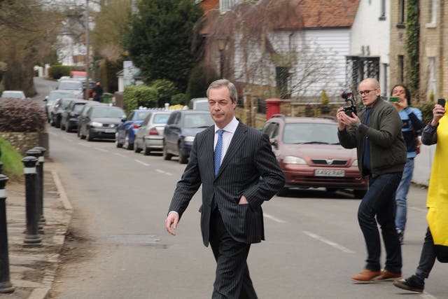Nigel Farage is pictured leaving the pub after the invasion by protesters 