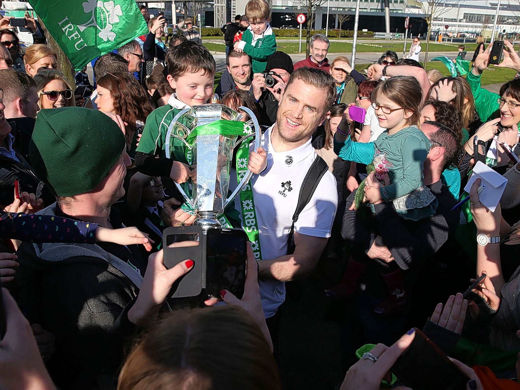 Jamie Heaslip is mobbed by fans as the Ireland team arrive at Dublin Airport with the Six Nations trophy on Sunday