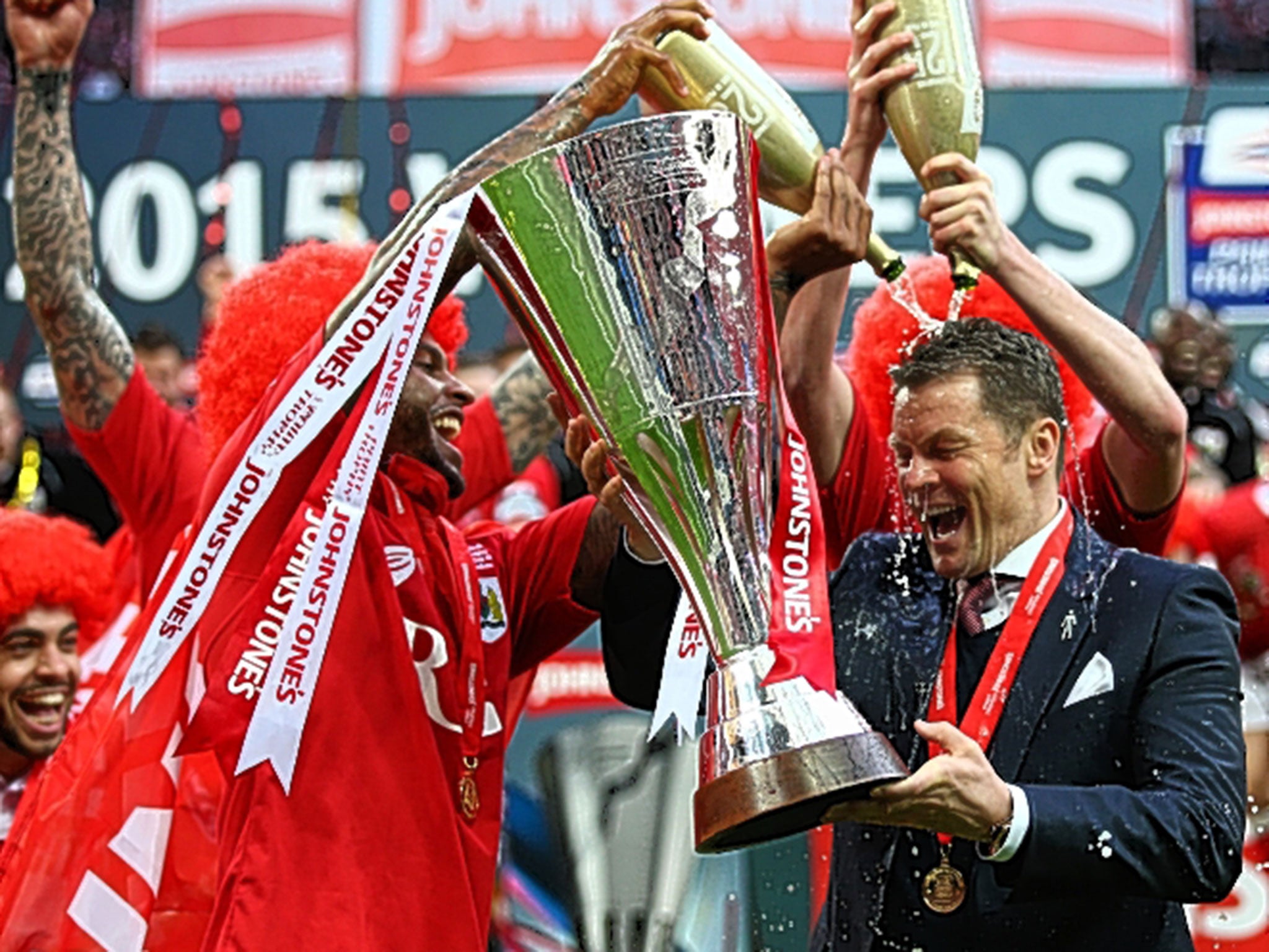 Steve Cotterill, the Bristol City manager, is drenched in champagne after Sunday’s victory at Wembley