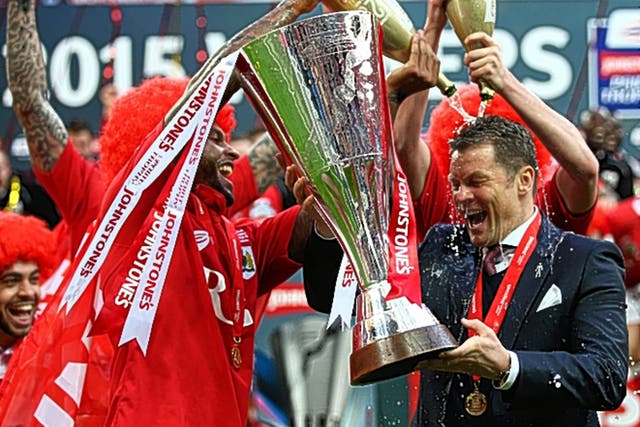 Steve Cotterill, the Bristol City manager, is drenched in champagne after Sunday’s victory at Wembley