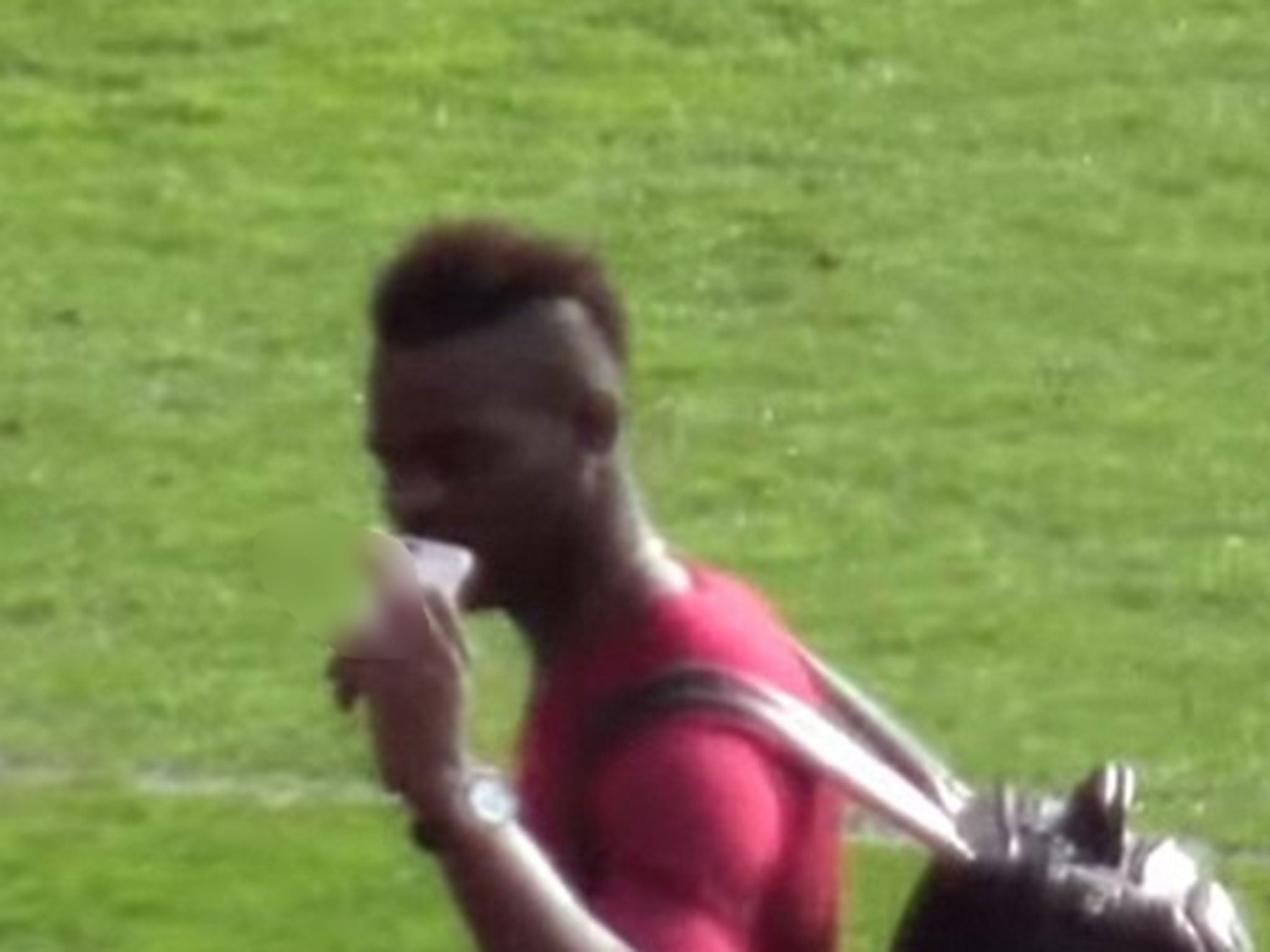 Balotelli then appears to flip his middle finger