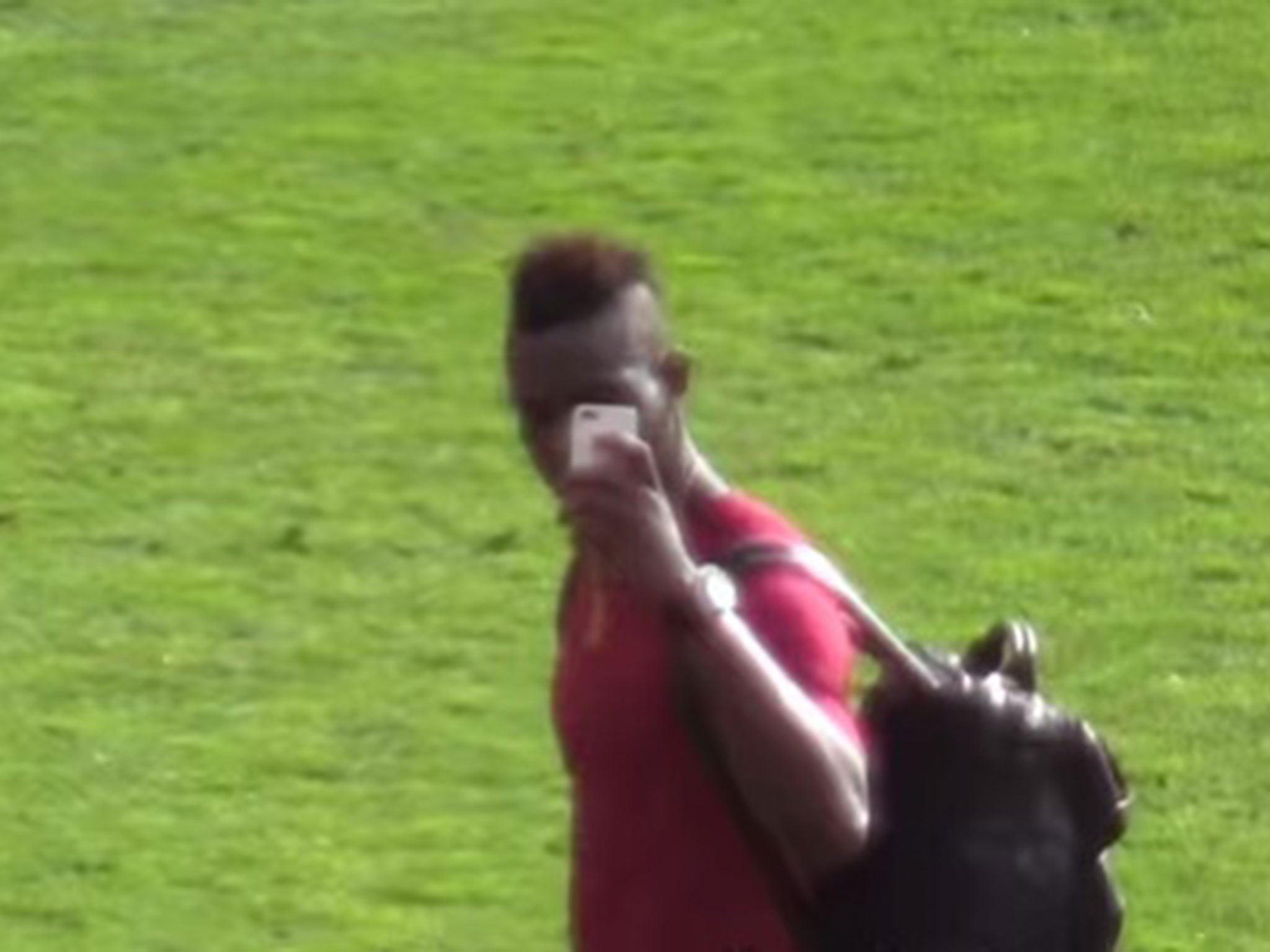 Mario Balotelli films United fans before making appearing to make an obscene gesture at them
