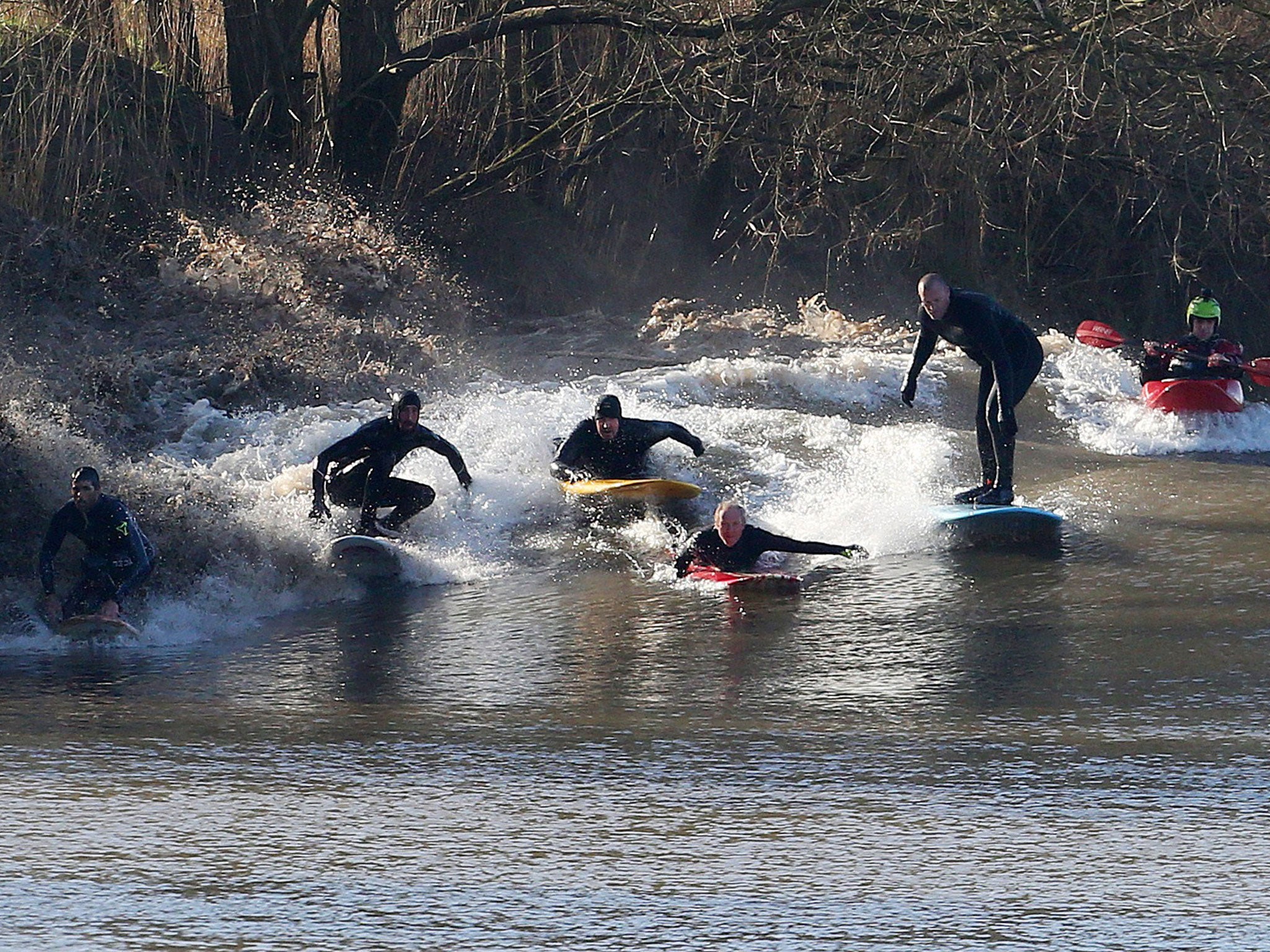 Surfers and kayakers surfing the tidal bore this weekend