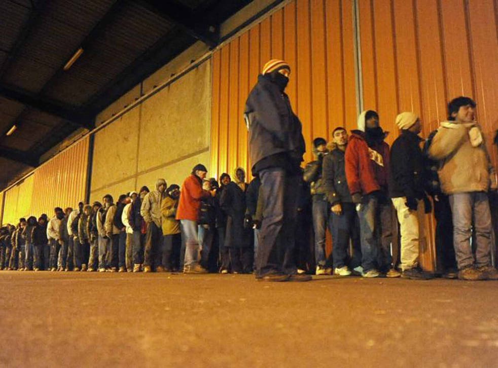 Hard line: migrants queue for food in Calais 