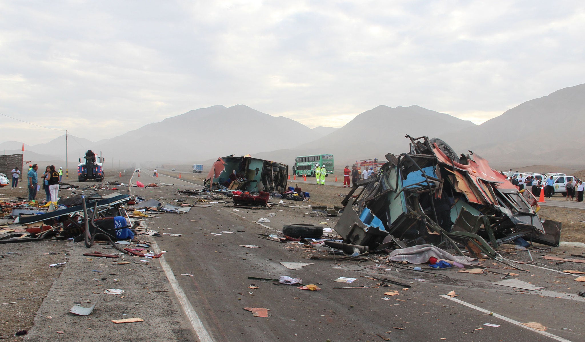 The rubble of crashed vehicles litters a coastal highway in Huarmey, Peru, Monday, March 23, 2015