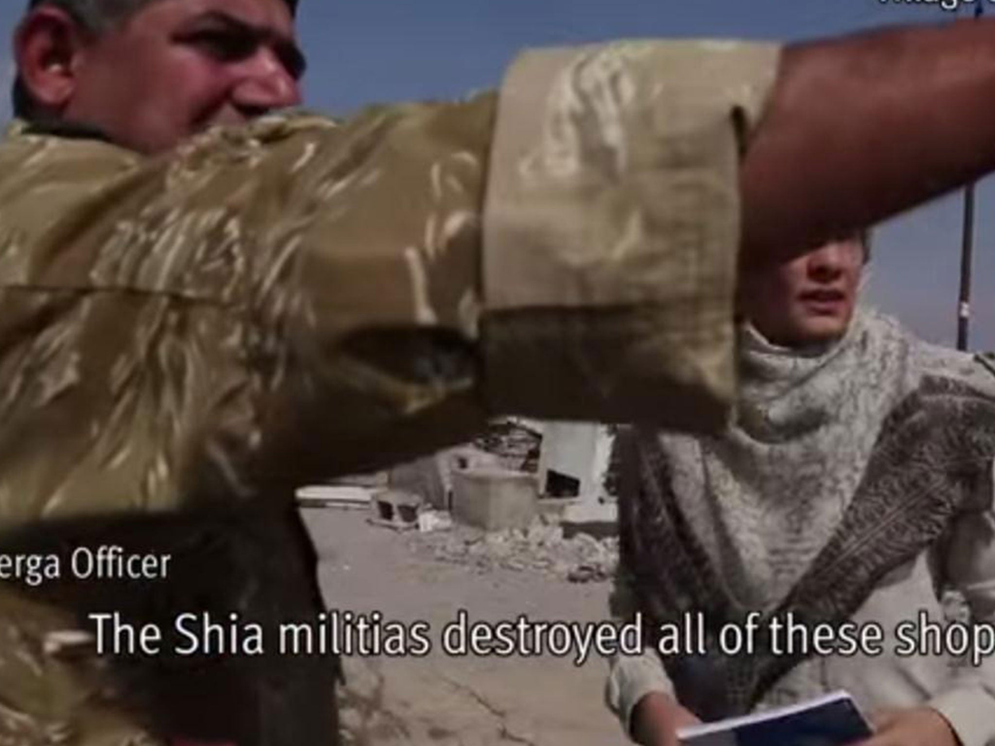 A Peshmerga officer shows HRW shops and homes that have been destroyed