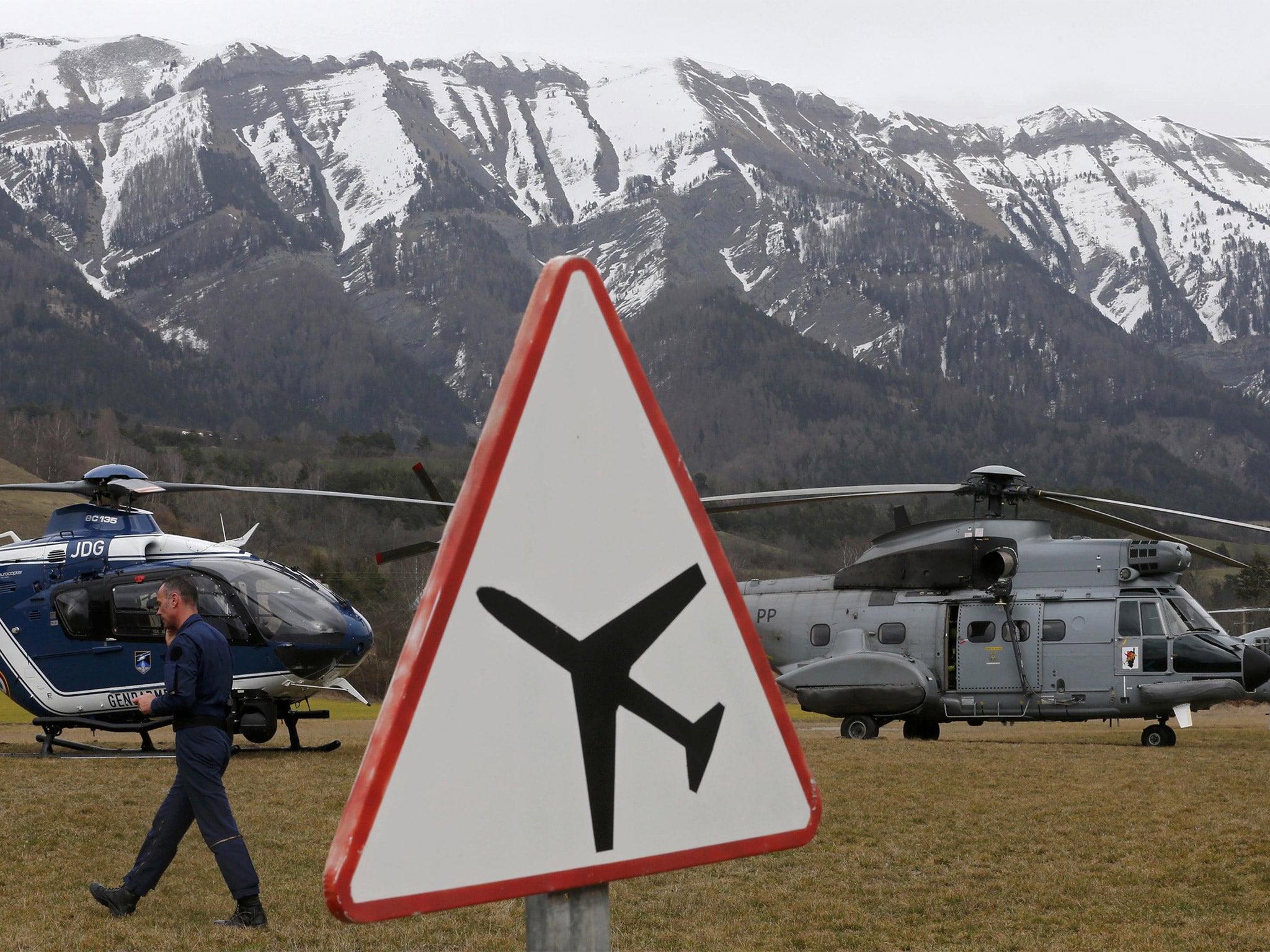 Rescue helicopters from the French Gendarmerie and the Air Force are seen in front of the French Alps during a rescue operation near to the crash site