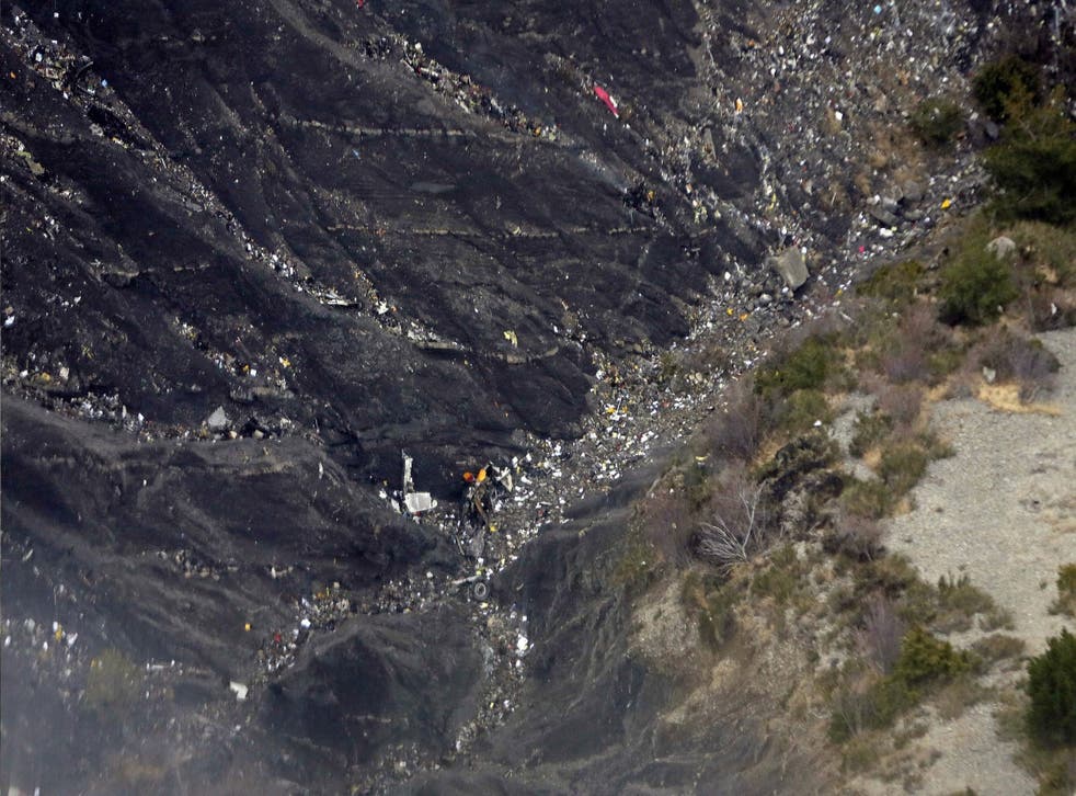 Wreckage and debris lie on the mountain slopes after the crash of the Germanwings Airbus A320 over the French Alps