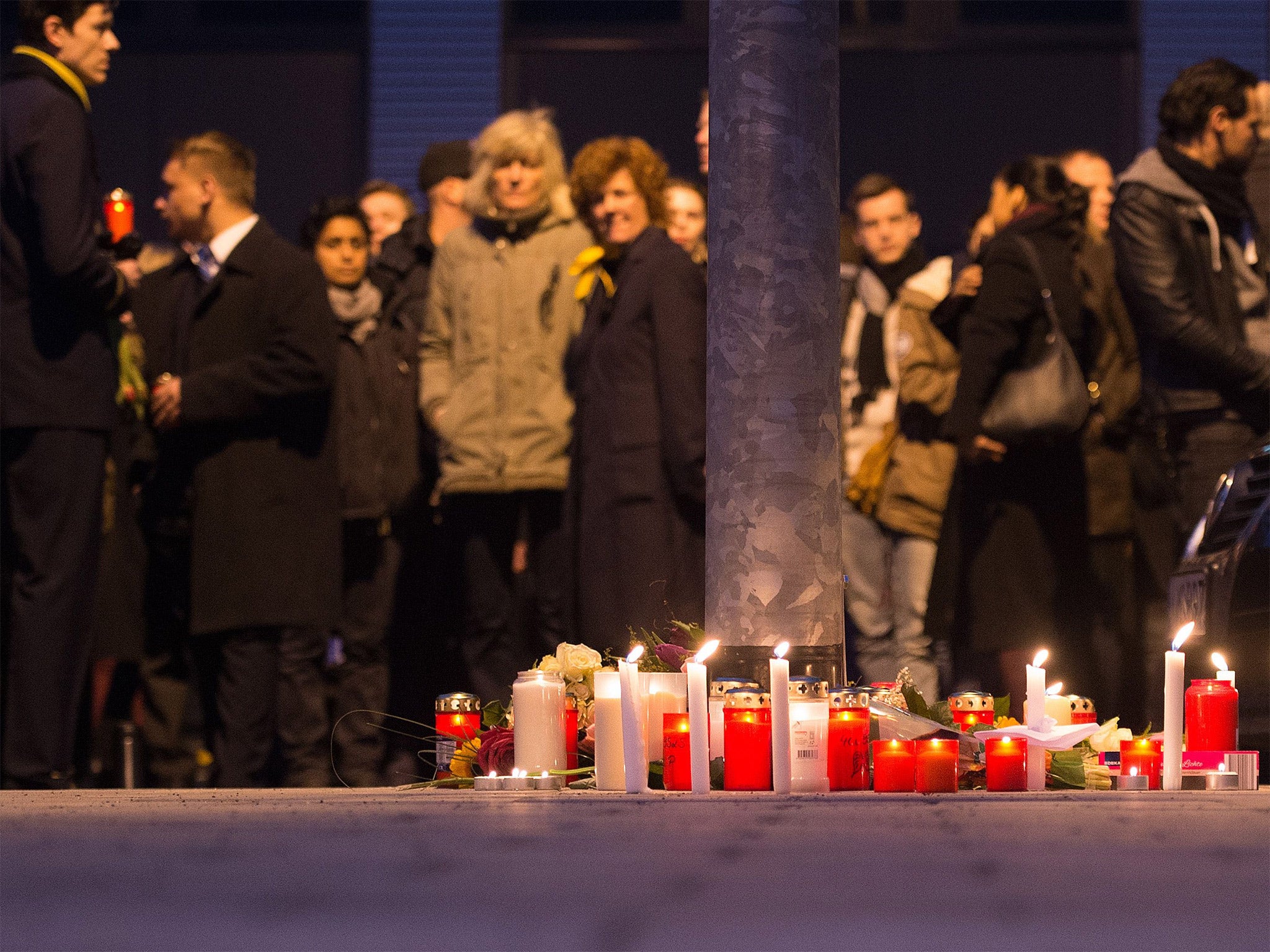 Staff members of Germanwings and Lufthansa hold a candlelight vigil outside their headquarters in Cologne