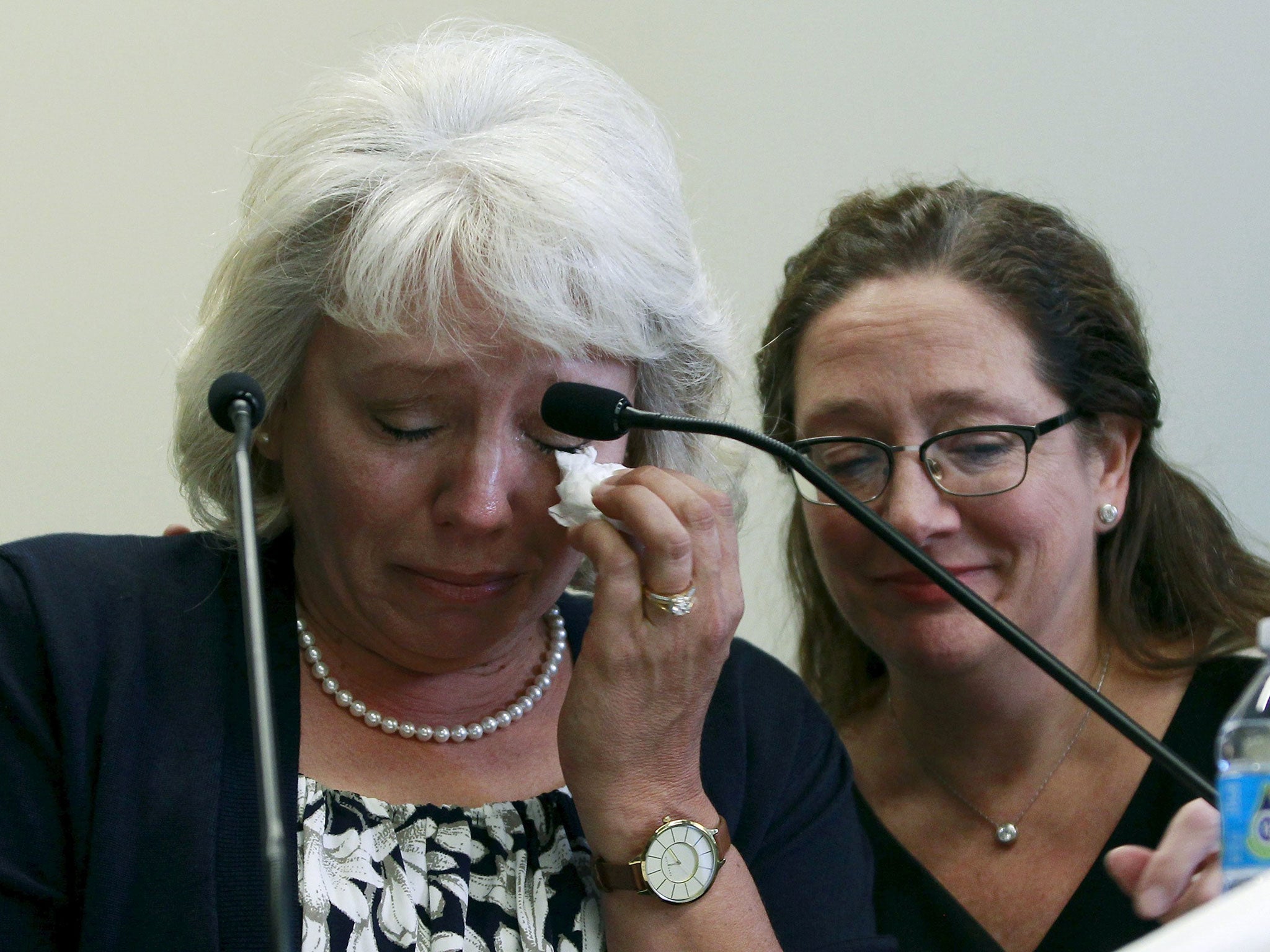 Debra Milke (L) is consoled by her attorney Lori Voepel during a news conference in Phoenix, Arizona on 24 March