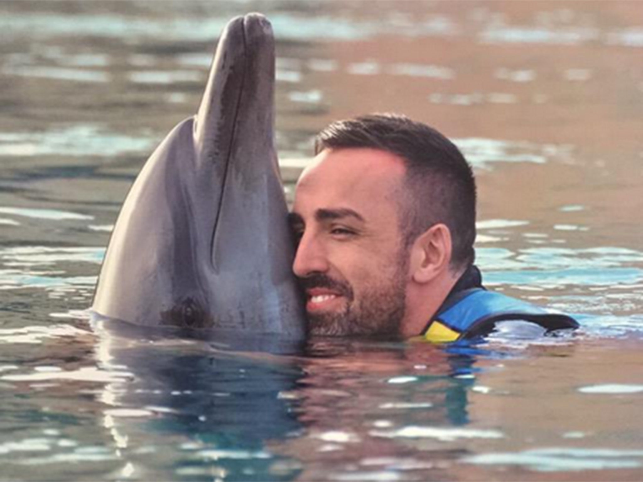 Jose Enrique swims with dolphins