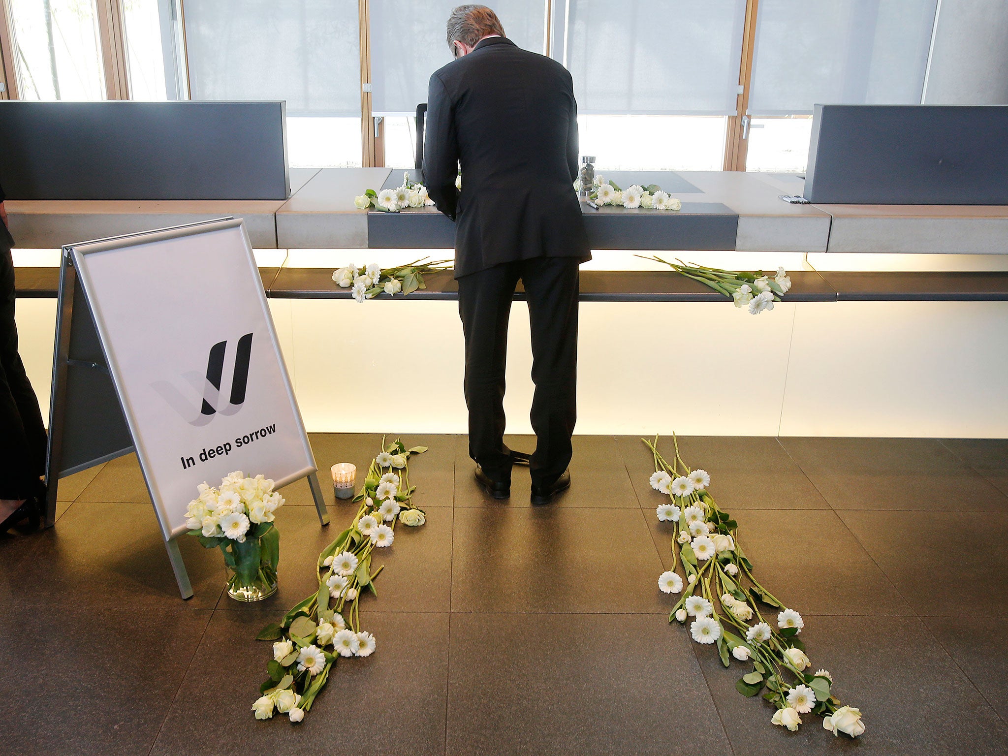 A Lufthansa employee signs in a condolence book in Frankfurt, Germany