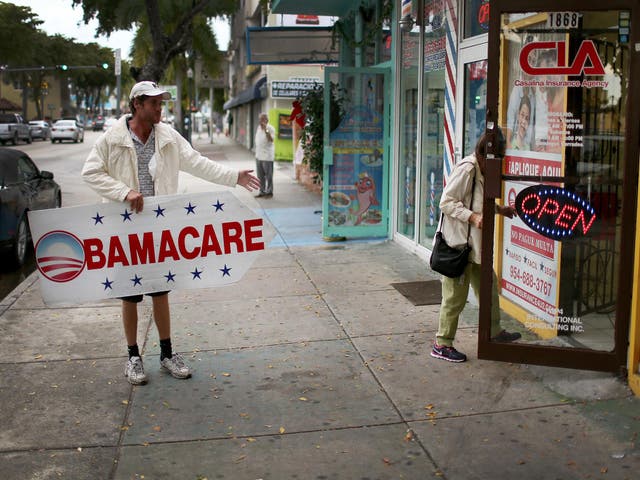 <p>Pedro Rojas holds a sign directing people to an insurance company where they can sign up for the Affordable Care Act, also known as Obamacare, before the February 15th deadline on February 5, 2015 in Miami, Florida</p>