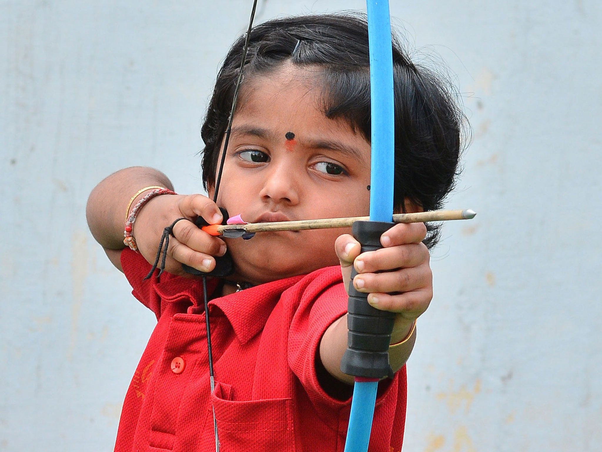 Two-year-old Indian archer Dolly Shivani Cherukuri takes aim as she sets a new record