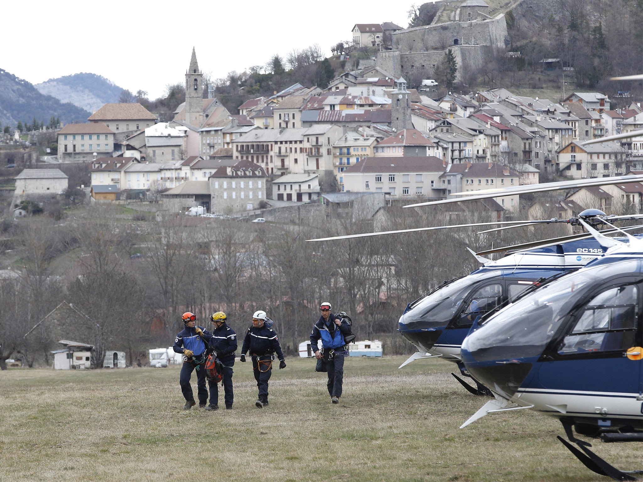 The nearby town of Seyne-les-Alpes overlooks rescue workers as they make their way to the crash site