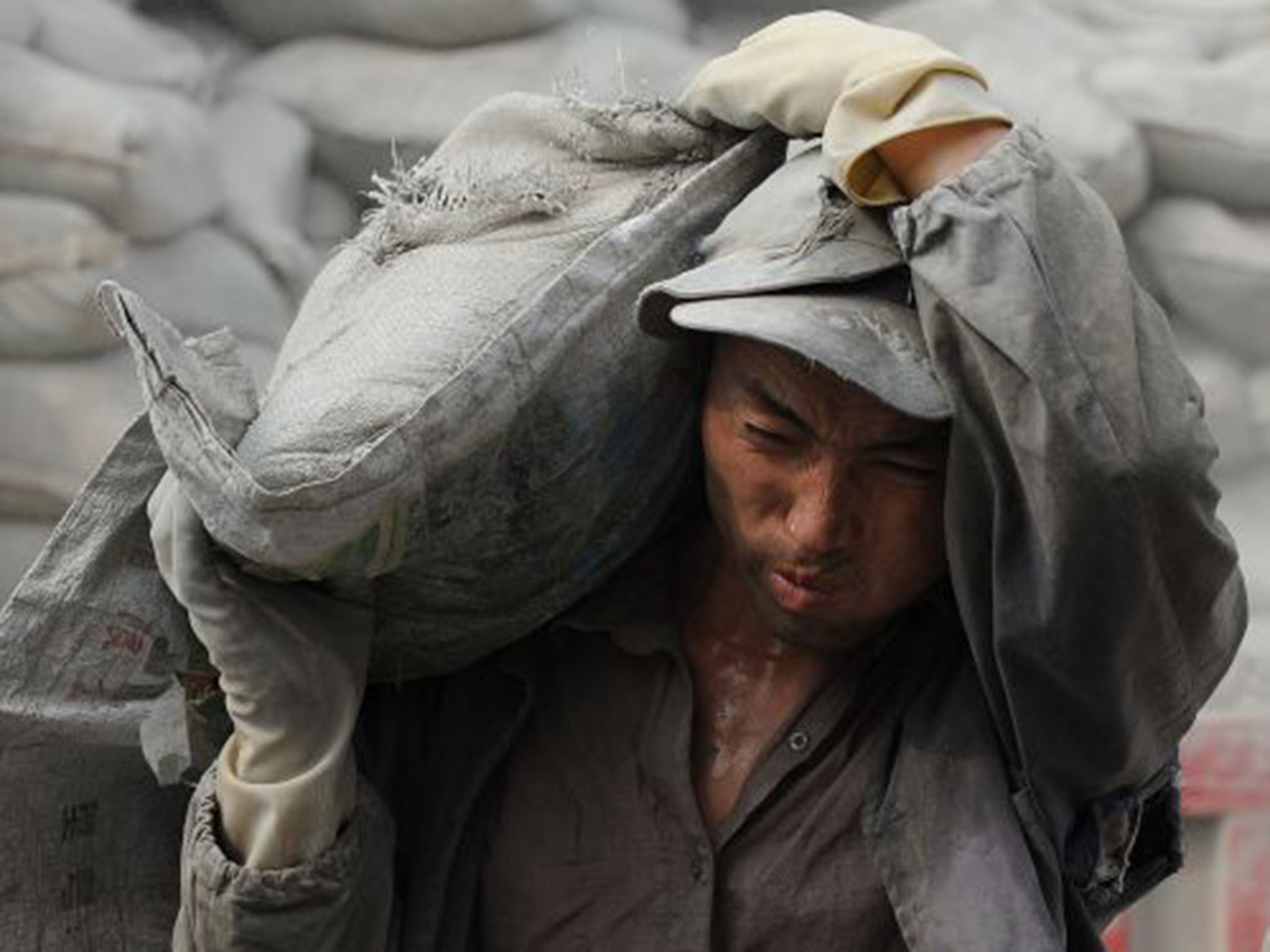 Grey matter: a Chinese worker delivers bags of cement at a construction site in Hefei in east China’s Anhui province
