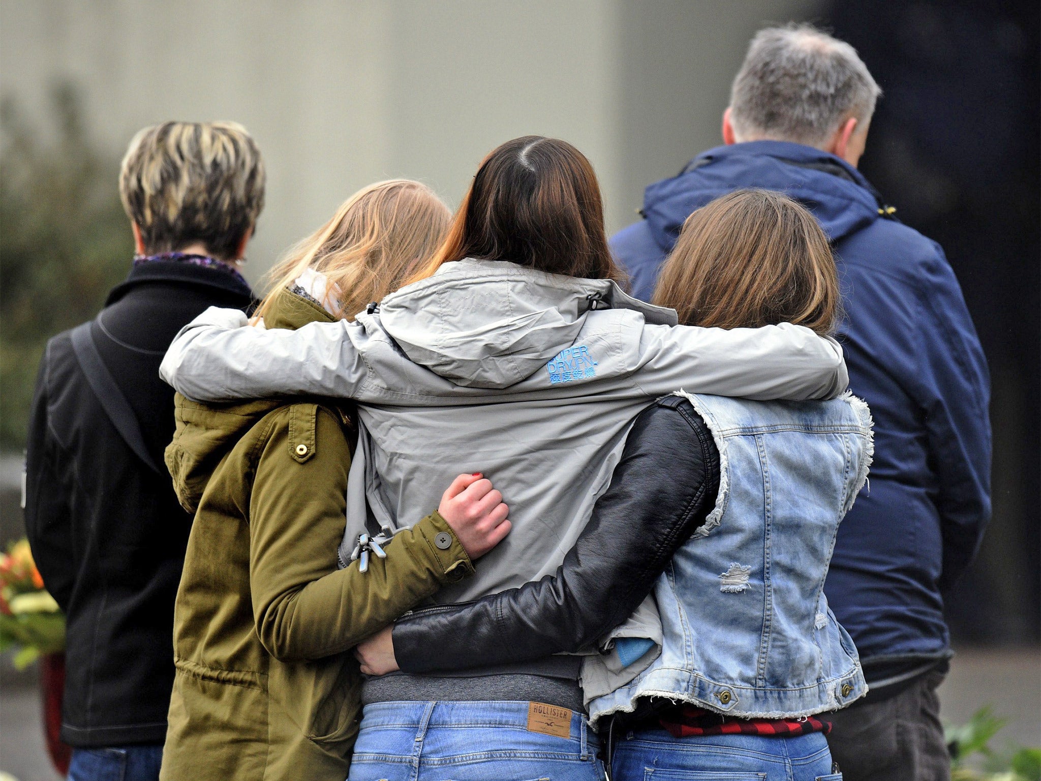 Students gather at a memorial in front of the Joseph-Koenig-Gymnasium school in Haltern am See