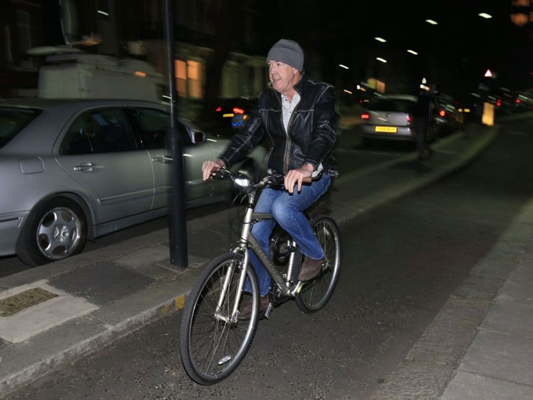 Jeremy Clarkson leaves his home in west London, on a bicycle. (Image: PA)