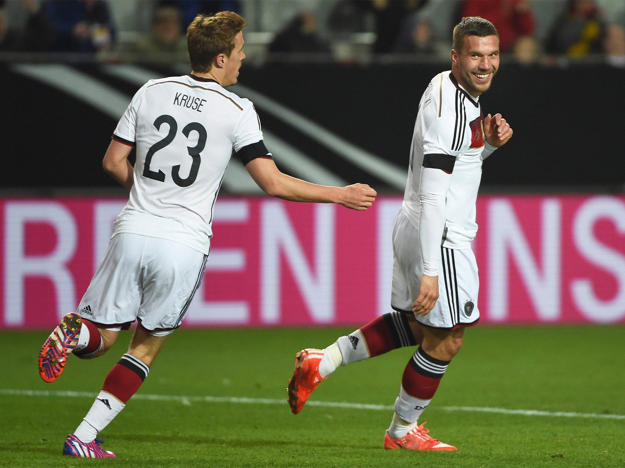 Lukas Podolski, right, celebrates his equaliser