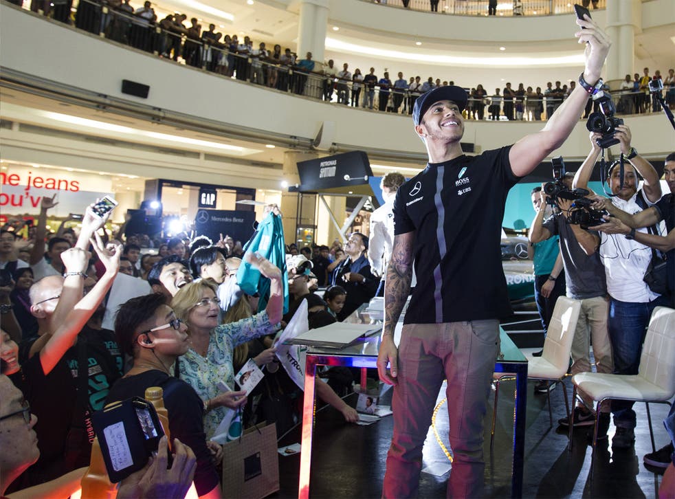 Lewis Hamilton takes a selfie during a promotional event in Kuala Lumpur on Wednesday