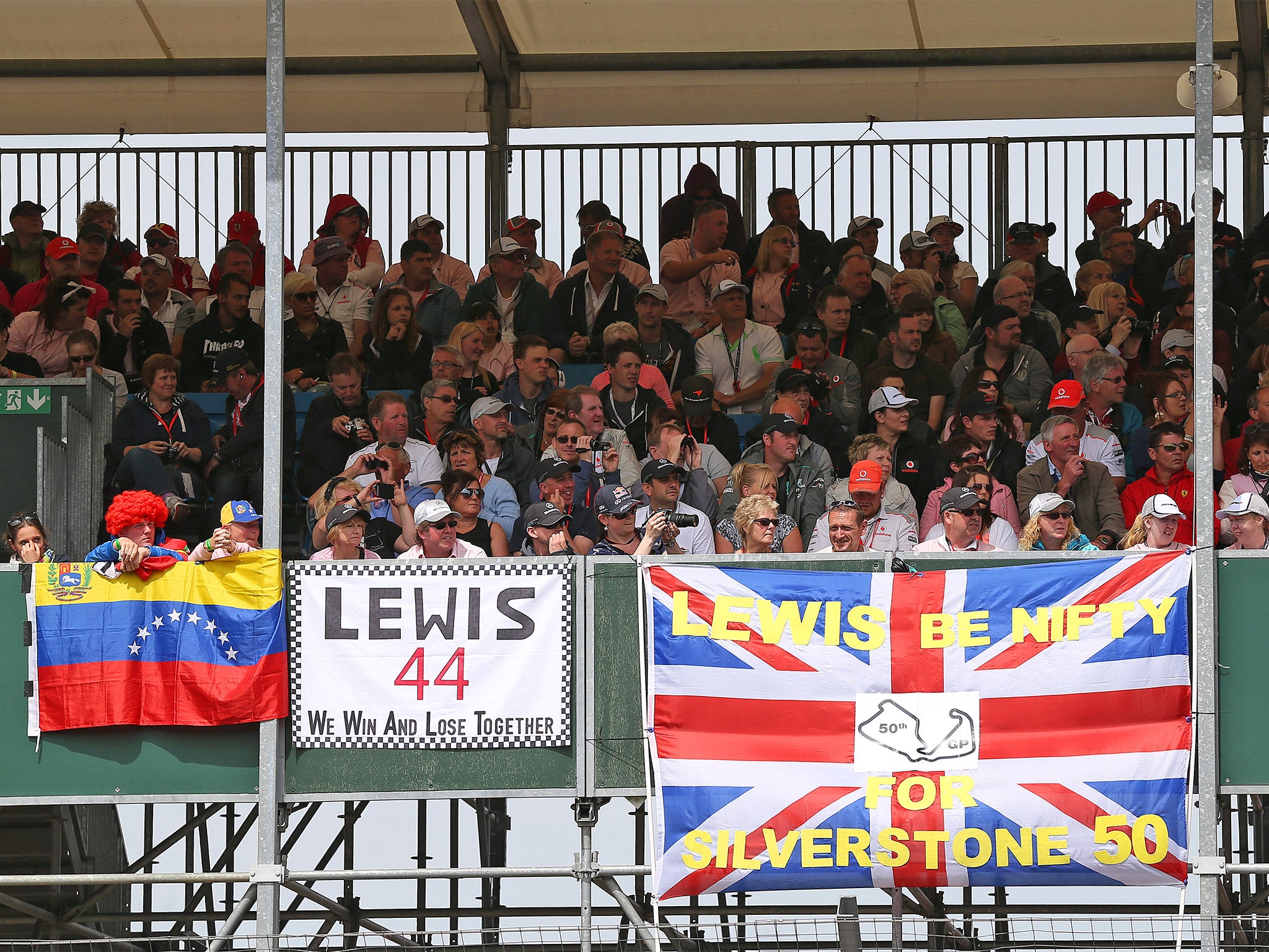 Fans of Lewis Hamilton watch their hero on his way to victory at the British Grand Prix at Silverstone last year