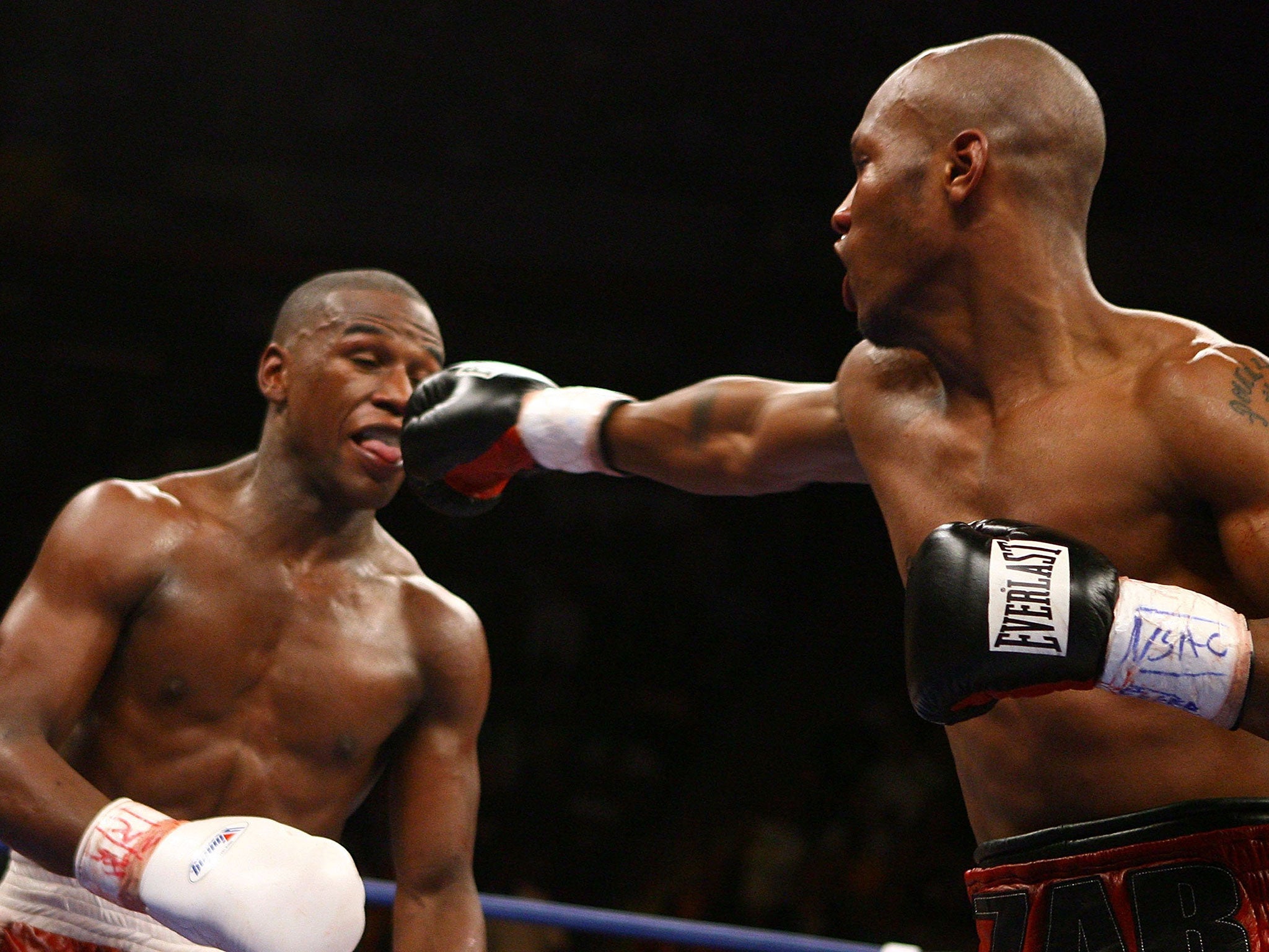Zab Judah (right) hits Mayweather during their fight in 2006