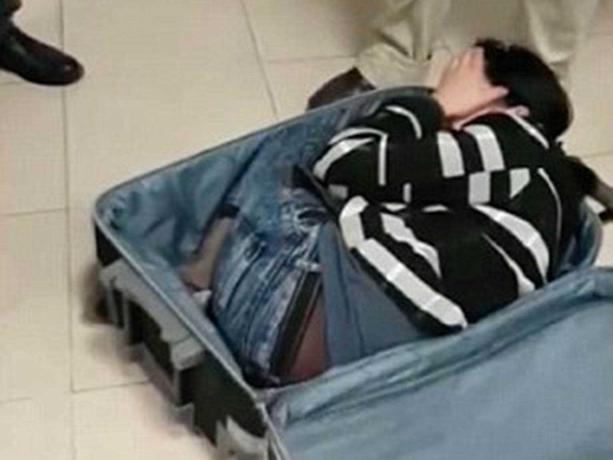 The woman was found curled up inside the suitcase
