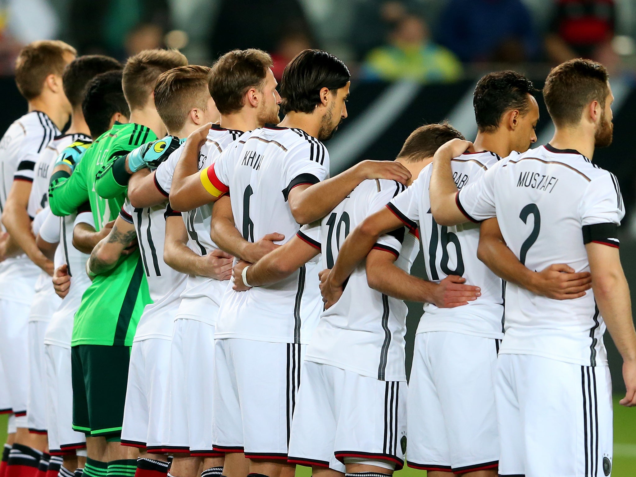 The German side stand in silence in tribute to the Germanwings victims