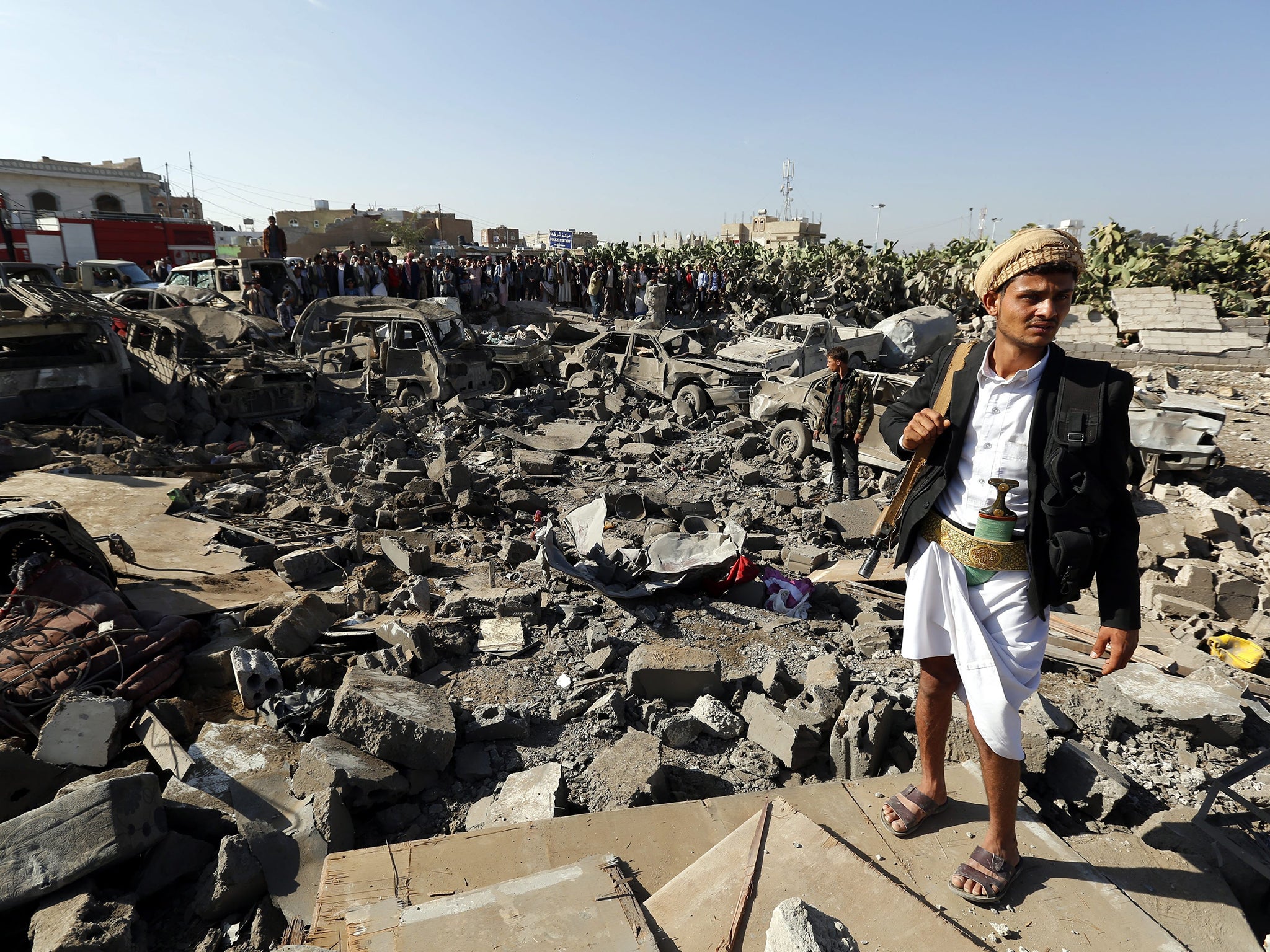 A member of the Houthi militia near vehicles destroyed
by a Saudi air strike in Sanaa yesterday