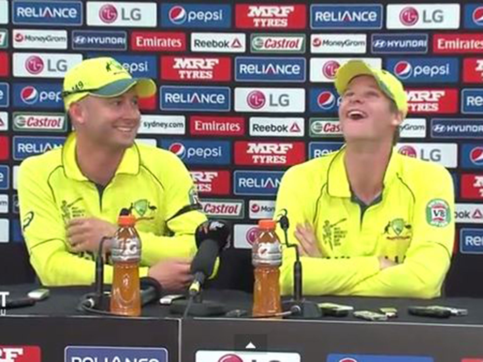 Michael Clarke and Steve Smith laugh after a question from BBC reporter Stephen Shemilt