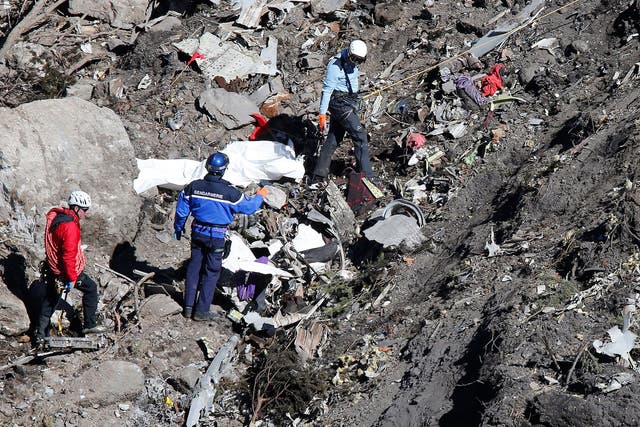 Search and rescue workers make their way through debris at the crash site of the Germanwings Airbus A320 that crashed in the French Alps, above the town of Seyne-les-Alpes, southeastern France 