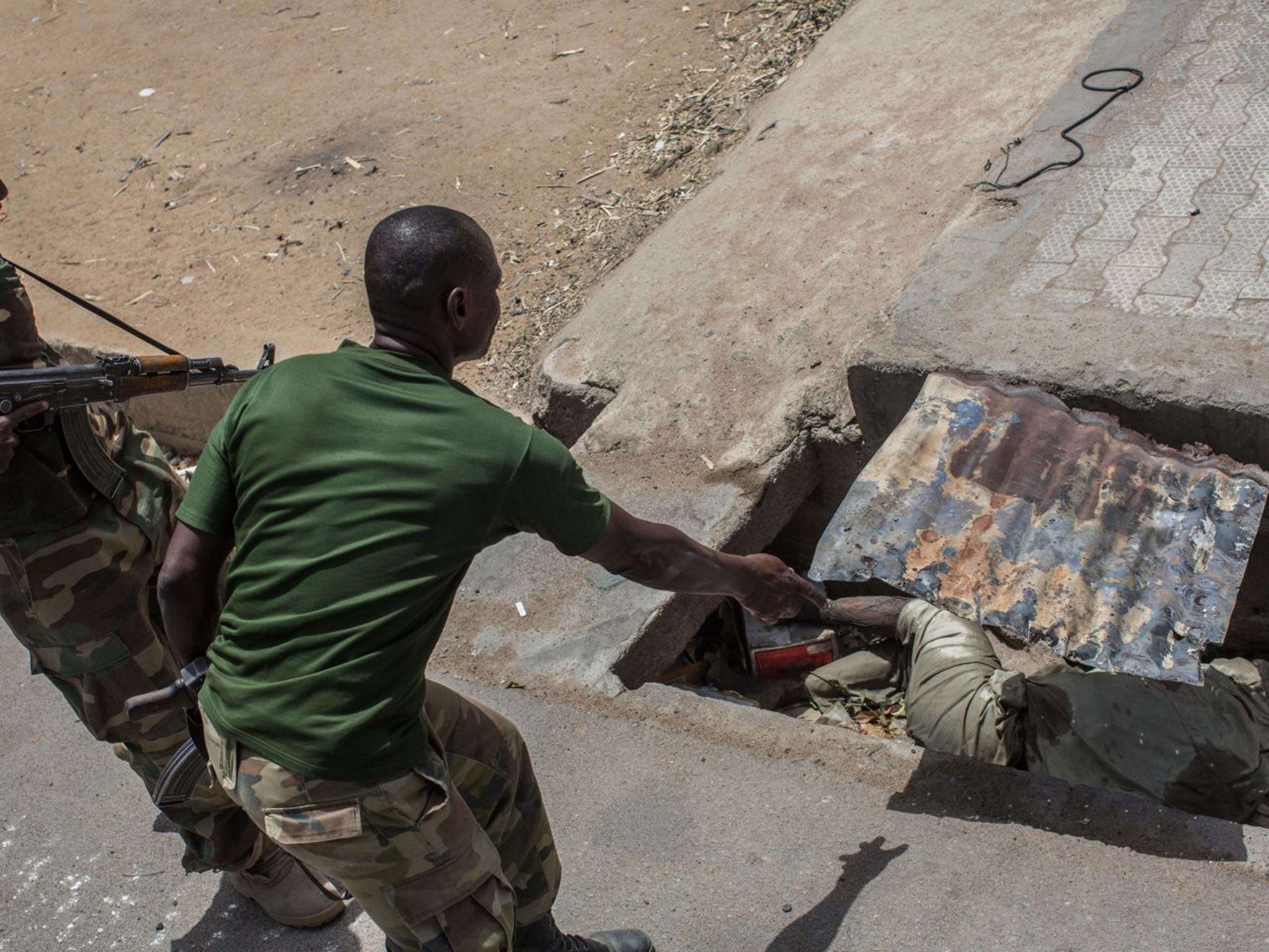 Soldiers find dead bodies in Bama's streets (AFP/Getty/Nichole Sobecki)