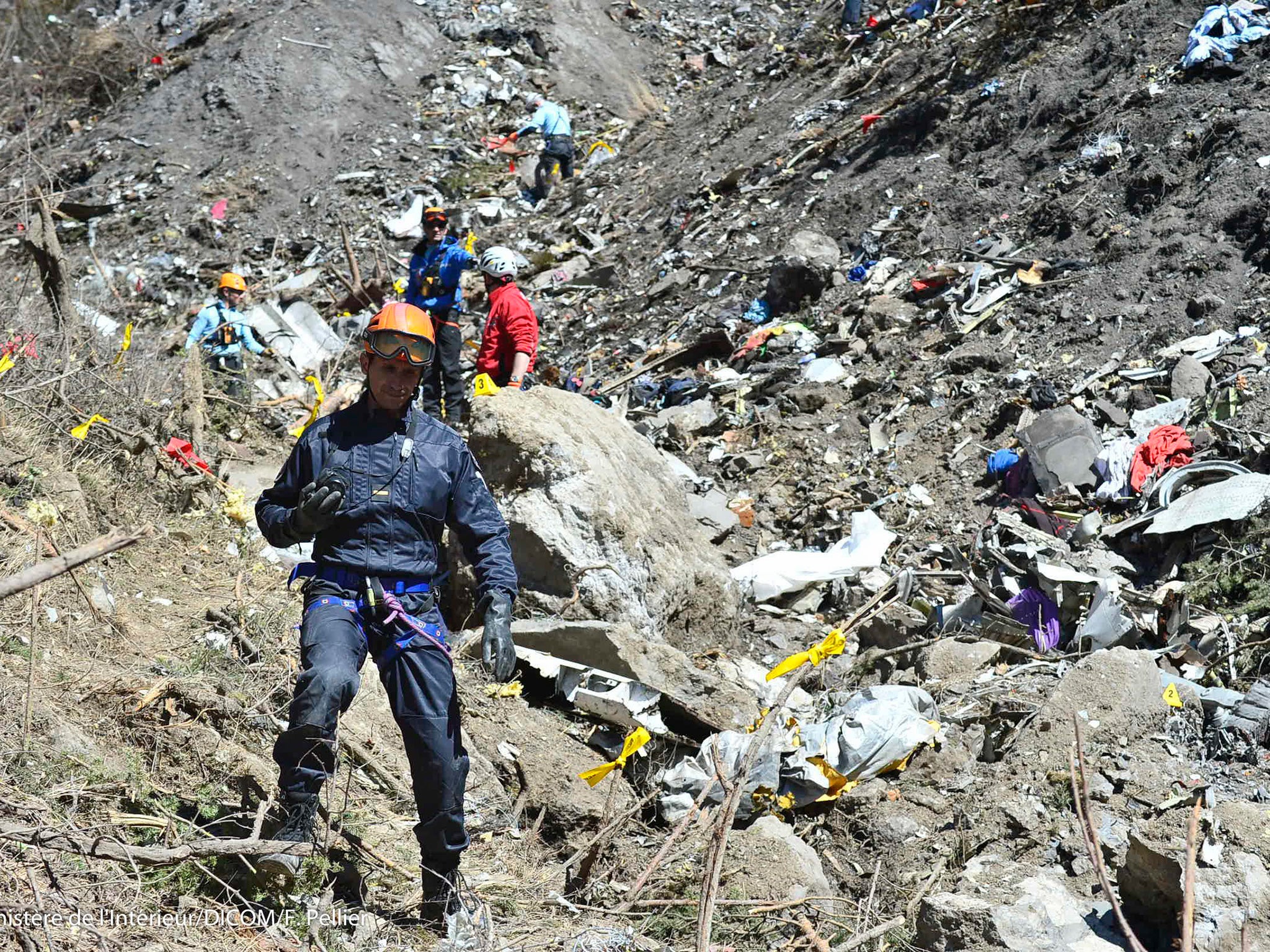 Search and rescue workers collecting debris at the crash site in the French Alps