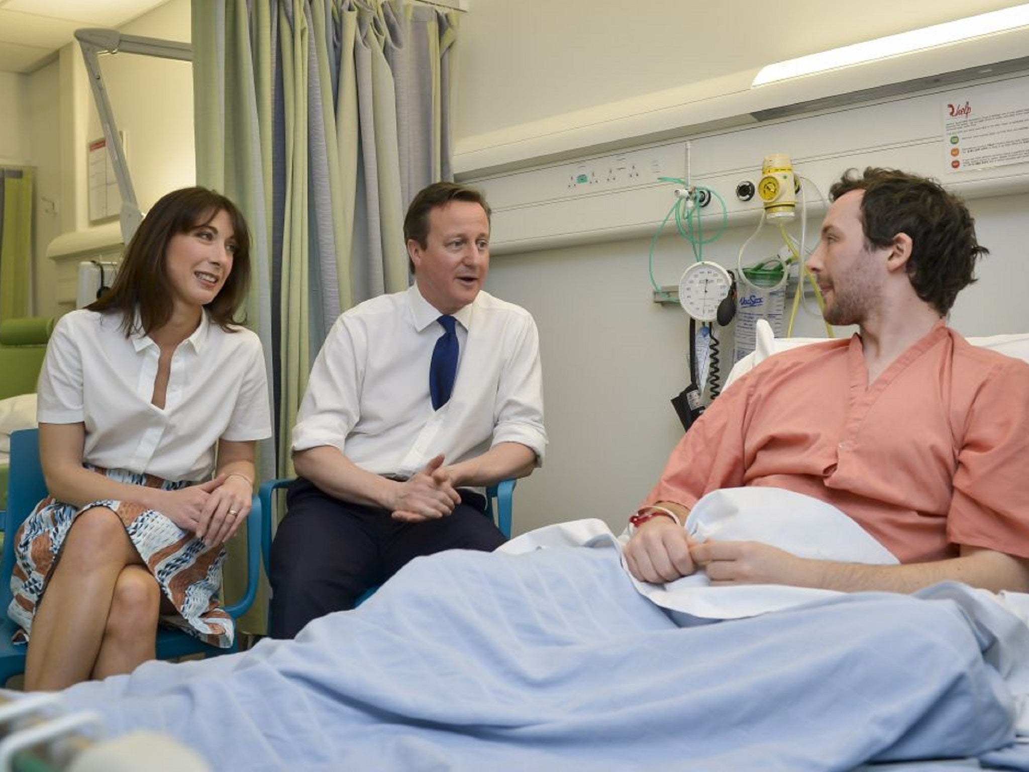 The Camerons talking to a patient at Salford Royal Hospital