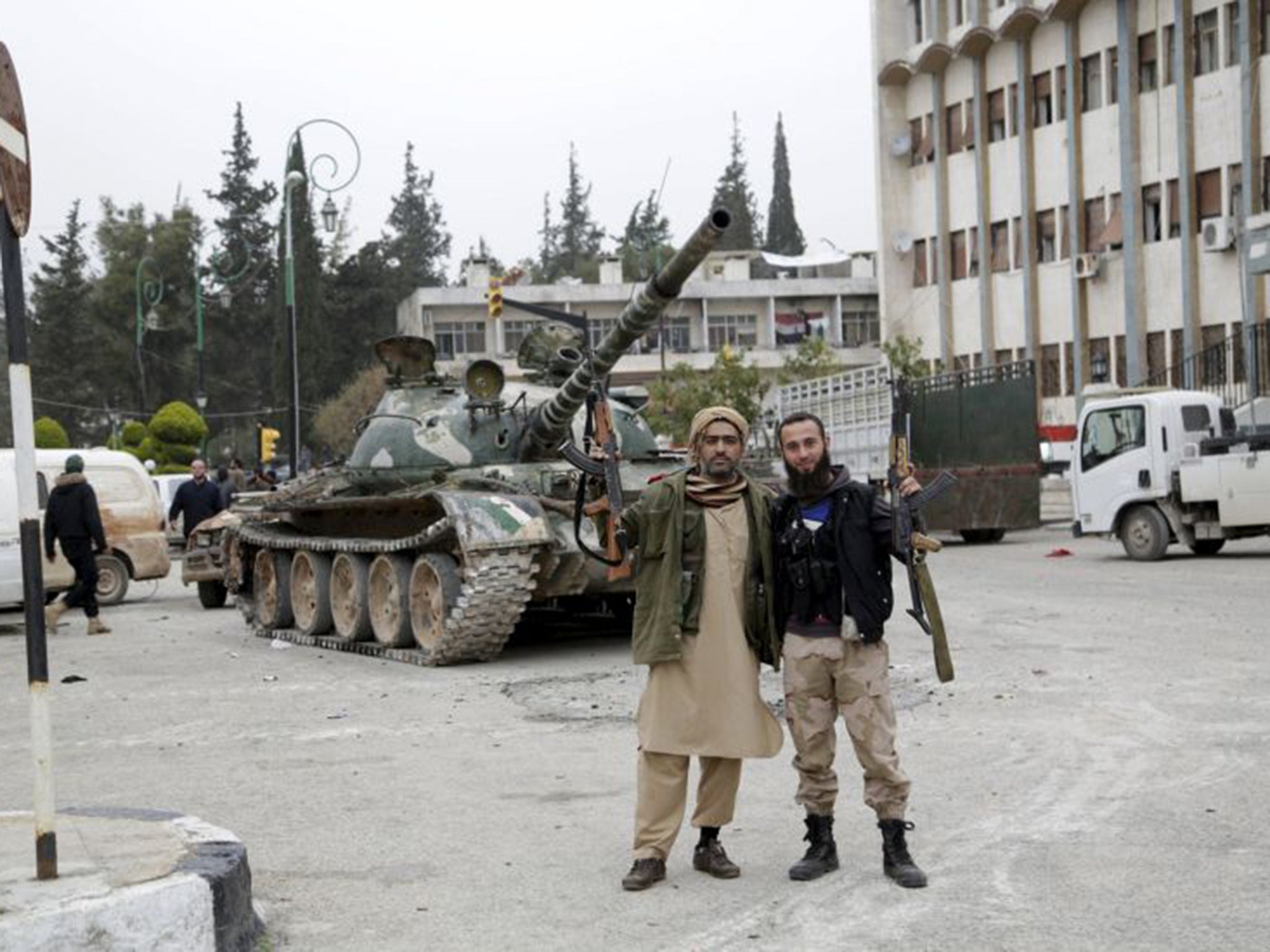 Jabhat al-Nusra’s fighters pose for a picture after the militants stormed Idlib on Saturday