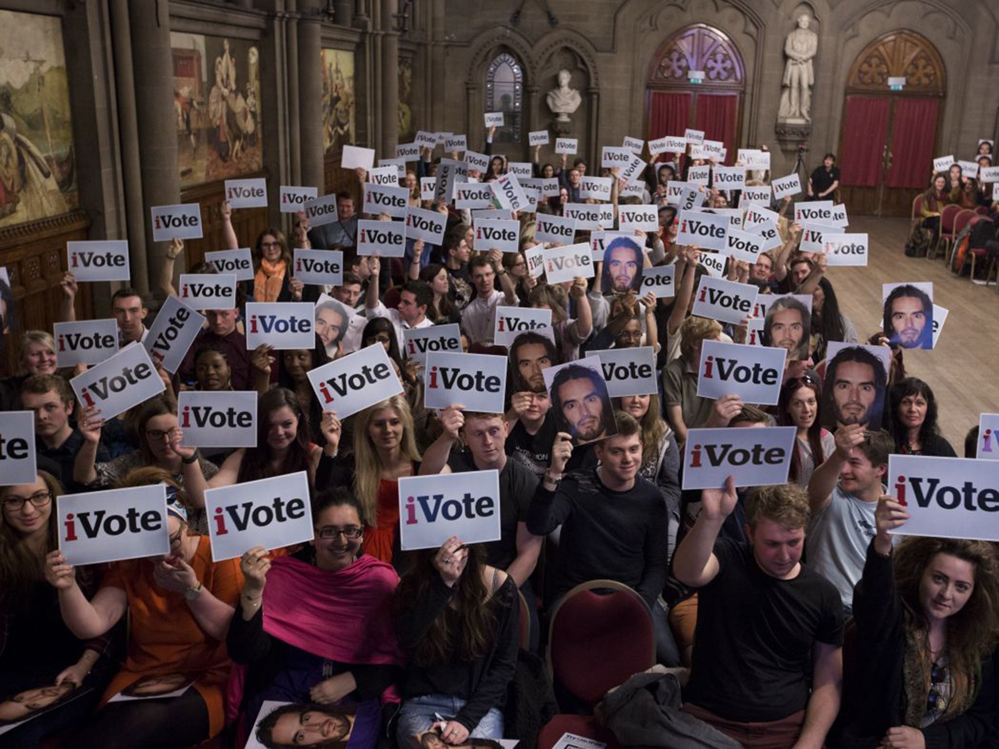 The audience expressing their opinion by showing placards at Manchester Town Hall during the Independent's idebate event for students