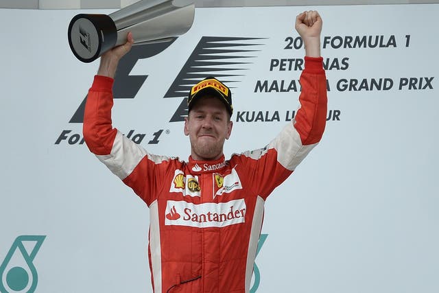 Sebastian Vettel lifts the Malaysian Grand Prix trophy
