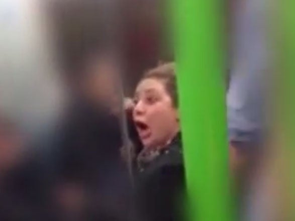 The woman was filmed shouting and swearing at two men for speaking in their 'own lingo'